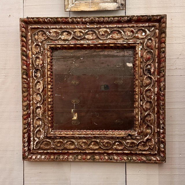 18th century Baroque mirror with a deeply carved frame of scrolling foliage between gadrooned borders, its painted and...