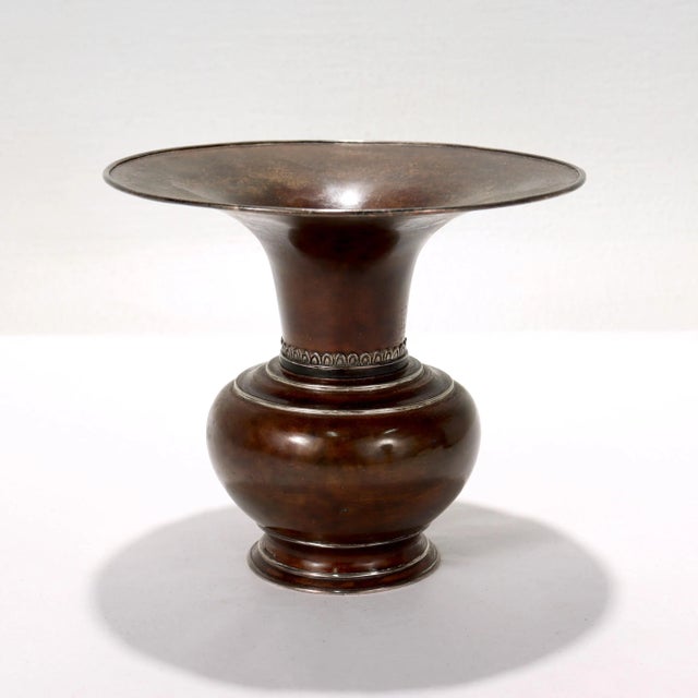 A fine antique Japanese flower vase. In hand-hammered copper (or possibly a thin-bodied bronze) with applied silver bands...