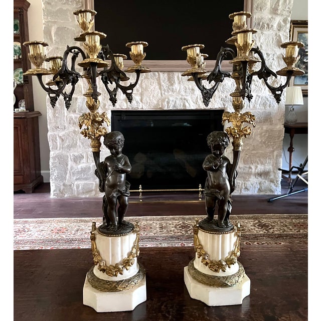 An exceptional and stately pair of 19th-century French Louis XVI-style figural candelabra. Boasting an impressive...