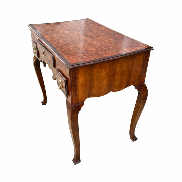 A fine English George I Period burr walnut lowboy. The rectangular top and drawers with wonderful burr walnut veneers....