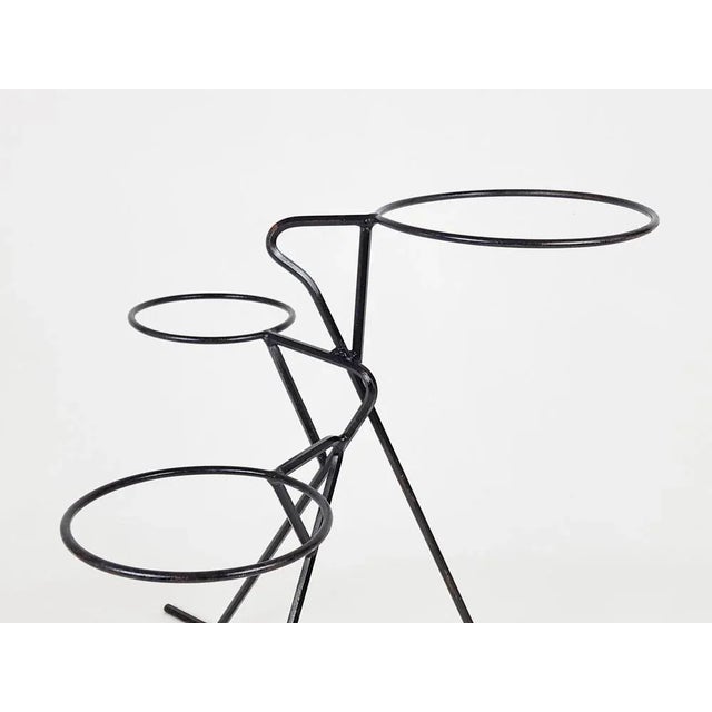 Free standing plants holder made from black metal rod with hexagonal and circular section. 1950s shape with 3 flower vase...