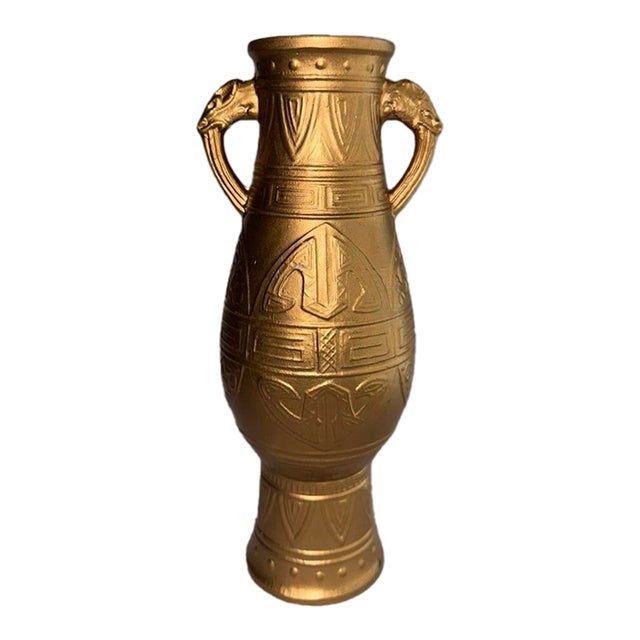 A Heavy, Gold Painted Decorative Vase With Animal Head Handles and Embossed Patterns. For Sale