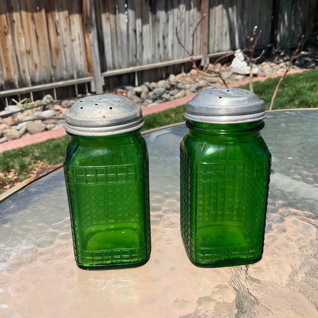 These green glass salt and pepper waffle pattern shakers were made by the Owen’s Glass Company and date to the 1950's and...