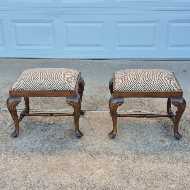 This is a timeless and versatile pair of vintage Queen Anne style walnut footstools or ottomans. They can be tucked under...