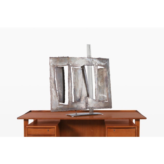 A striking early work by John Balossi (1931–2007), this 1967 welded steel sculpture draws you in with its bold, geometric...