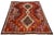 This beautiful Vintage Shiraz Handmade Wool rug features a timeless red field accentuated by striking blue and orange...