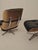 Set consisting of an eames lounge chair and ottoman. Upholstered in black leather and walnut. Likely made after 1989, as...