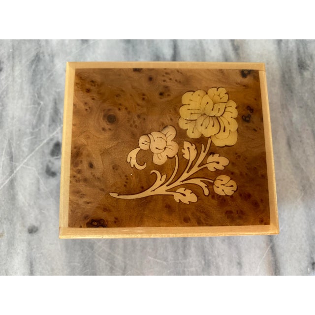 A nicely crafted wooden music box with marquetry woodwork and a small jewelry compartment inside. I especially like how...