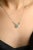Everyday Emerald and Diamond Necklace with Chain in 18K Gold studded with round cut emerald and round cut diamonds. This...