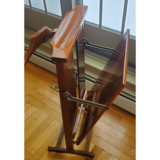 A vintage Italian valet stand made by Fratelli Reguitti. The stand features a built in hanger, as well as a folding...