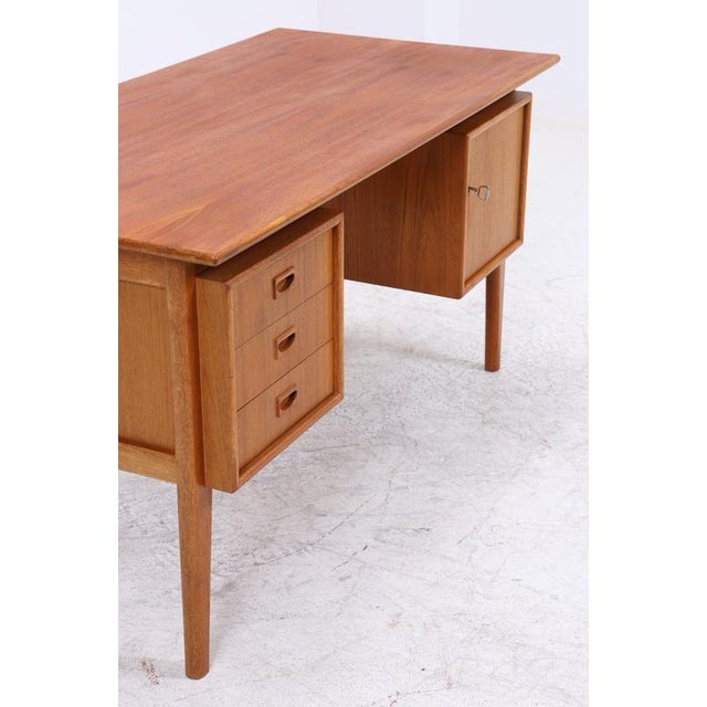Vintage teak desk with clean lines and a beautiful, even grain. Three drawers are located on the left, and a lockable...