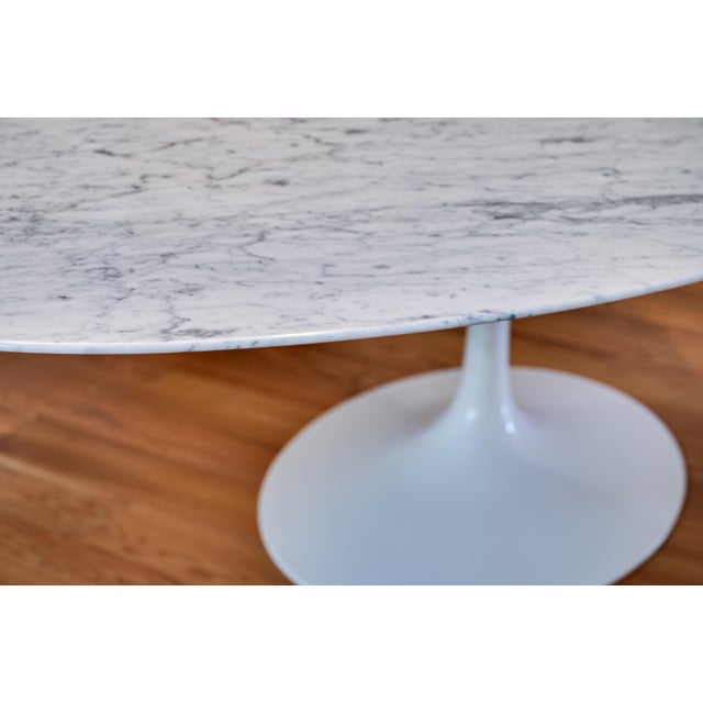 Authentic 96 inch Eero Saarinen Tulip dining table by Knoll with carrera marble top and white base. This table is in...