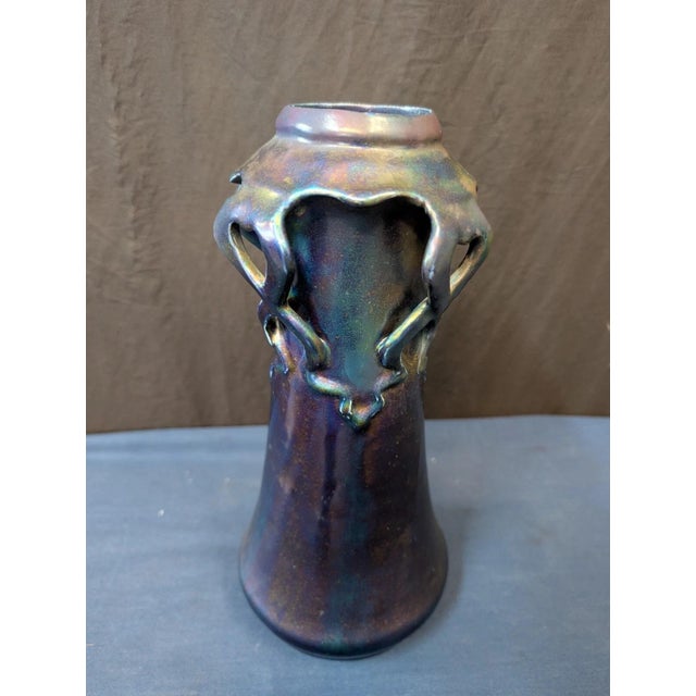 This vintage early twenteeth century art pottery vace is beautifully rendered with a wonderful dark iridescent glaze. The...