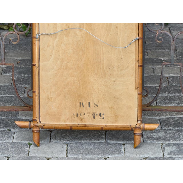 With its sharply tapered corners and warm faux bamboo detailing, this French mirror from circa 1900 captures the...