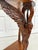 This striking early 20th century, likely 1920-30s, carved wood demi-lune table features an extraordinary sculptural swan...