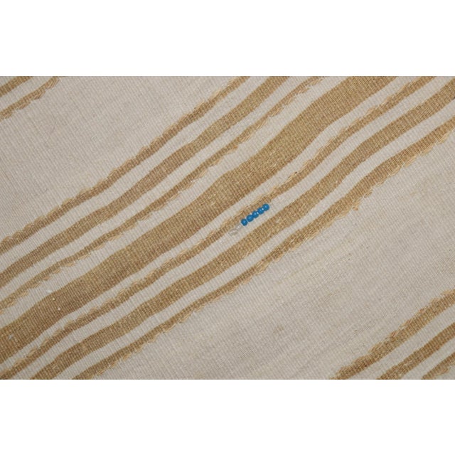 A mid-20th-century ivory and light brown Turkish Kilim striped runner
