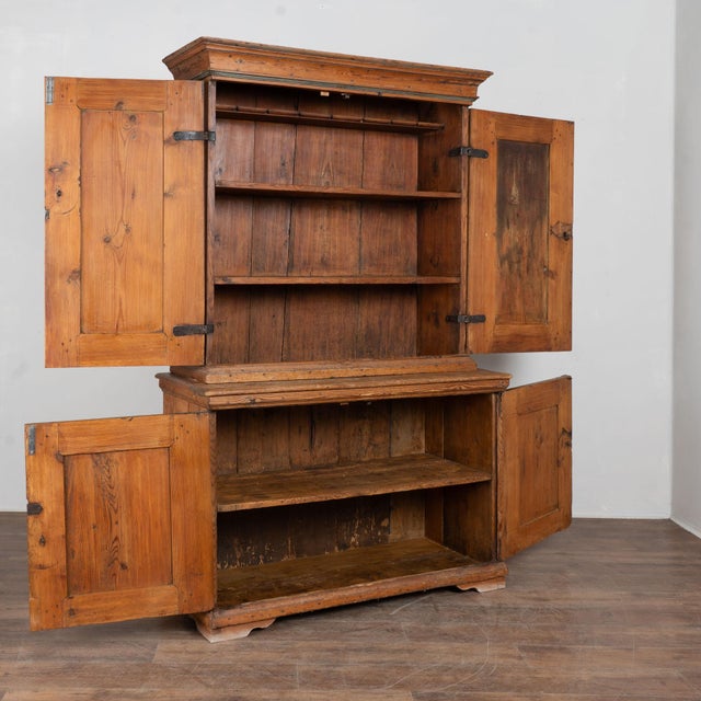 Early 19th century Swedish country cabinet crafted in pine. The cabinet retains its original painted panels featuring a...