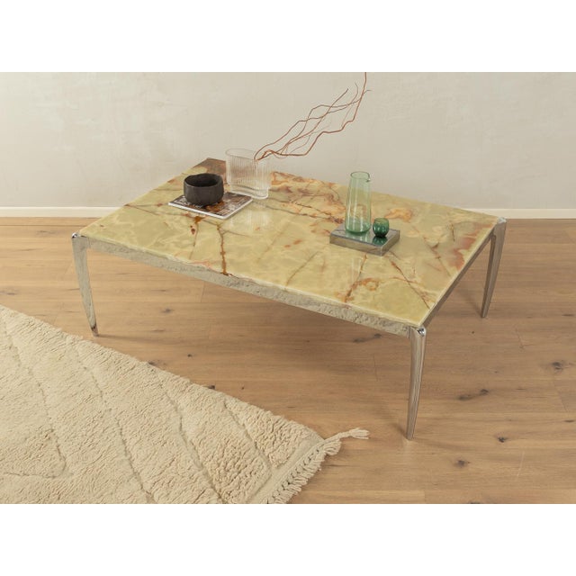 Wonderful coffee table from the 1960s. Chrome-plated stainless steel frame with an onyx marble tabletop in cream and brown...