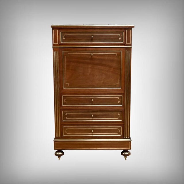 This superb Louis XVI secretary desk in solid mahogany and mahogany veneer captivates with its balanced proportions and...