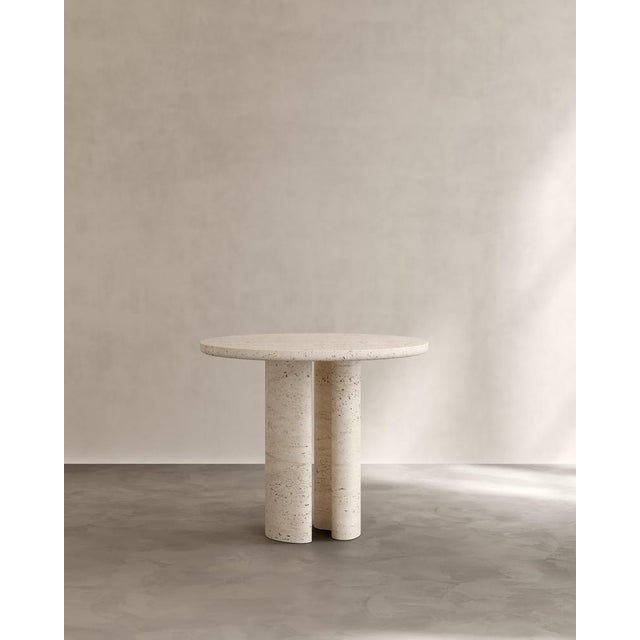 Roman dining table i in navona travertine by paloma editions dimensions: d 90 x w 90 x h 75 cm. Materials: travertine. The...