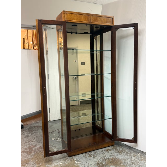 Design Plus Gallery presents a Vintage Campaign Style Curio Display Cabinet. The cabinet is detailed with burl wood...