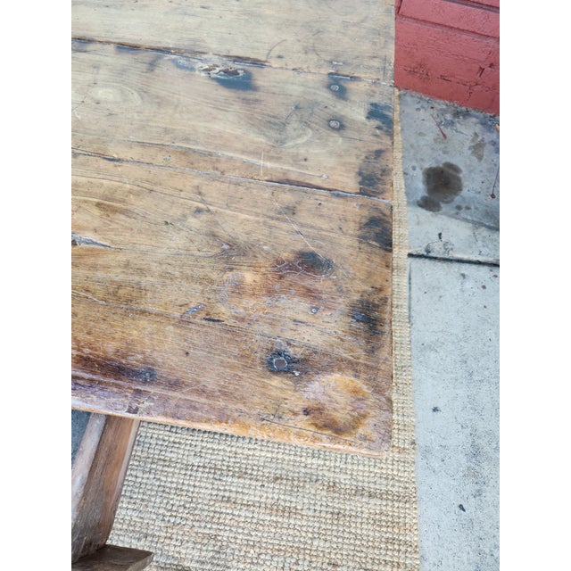 Rustic coffee table is constructed from solid teak wood with a natural, weathered finish. It has two functional drawers...
