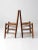 A pair of antique splint-weave seat chairs with a rustic, timeworn character. The wooden chairs feature classic ladder...