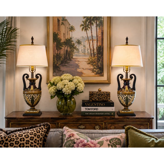 A wonderfully exuberant pair of vintage porcelain table lamps in the Hollywood Regency taste, designed as classical...