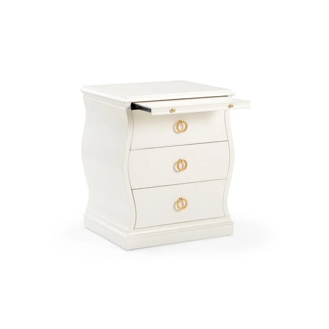 Adorable bedside chest with sweeping sides and gold leaf finished pulls. Not intended for clothing storage. Designed by...