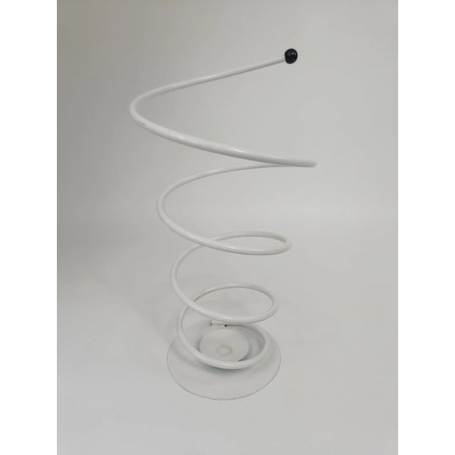 Pop Art spiral umbrella stand from the 80s. This metal box is white lacquered and has a plastic white cap at the end. The...