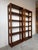 A striking pair of 1970s Mid-Century Modern six-tier bookcases in the style of Lou Hodges, expertly crafted from solid oak...