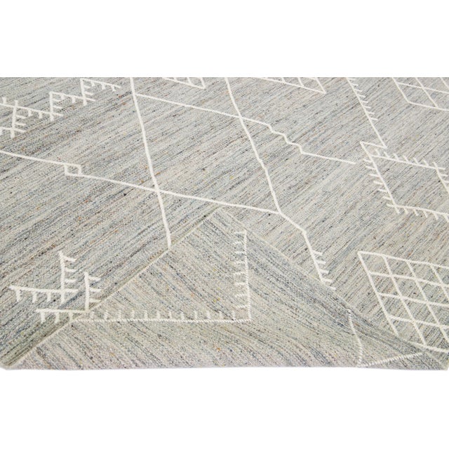 Beautiful kilim handmade wool rug with a gray field. This custom modern flatweave rug part of our Nantucket collection has...