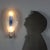 A 1960s-style glass and metal wall light with an elegant and functional structure. The curved, transparent glass is...