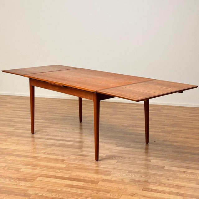 The dining table was made in Denmark in the 1950s-60s. It is made of teak veneer on the top and teak wood in the...