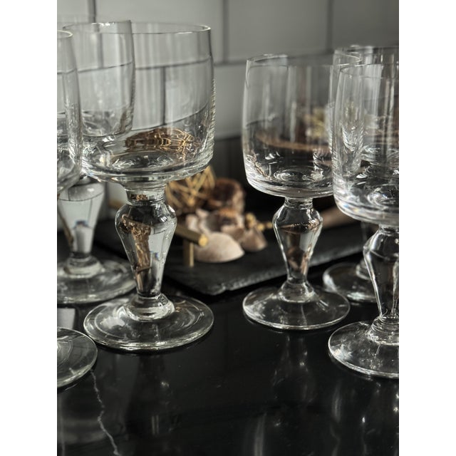 A sculptural set of eight mid-century Swedish crystal goblets featuring heavy baluster stems and a rare graduated two-...