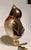 Beautiful old world glass blown songbird ornament in shades of silver and brown with a red breast and completed with gold...