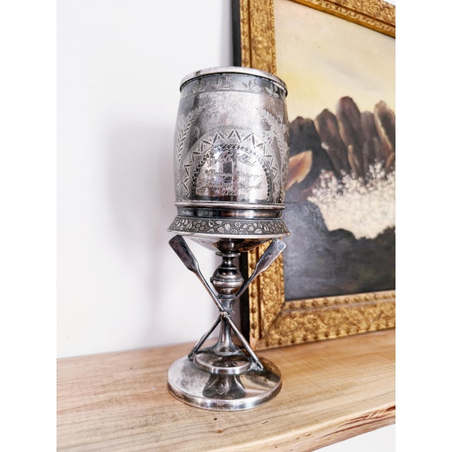 A lovely antique circa 1888 silver plated trophy cup with figural oars and rope at the base, engraved with a beautiful...