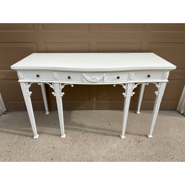 An elegant Maitland-Smith console table in the Chippendale taste, featuring finely carved mahogany construction finished...
