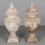 A pair of French terracotta garden urns with lids. Classical vase form on pedestal base, decorated in acanthus leaf motif...