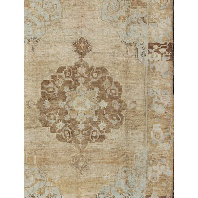 Measures: 7'5 x 10'8. Vintage Turkish Kars rug with floral medallion in camel, tan, taupe, gray, sand, Keivan Woven Arts,...