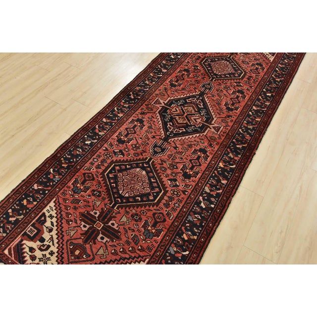 An authentic vintage tribal Hamedan runner hand-knotted with fine wool and natural dyes. This nomadic oriental rug...