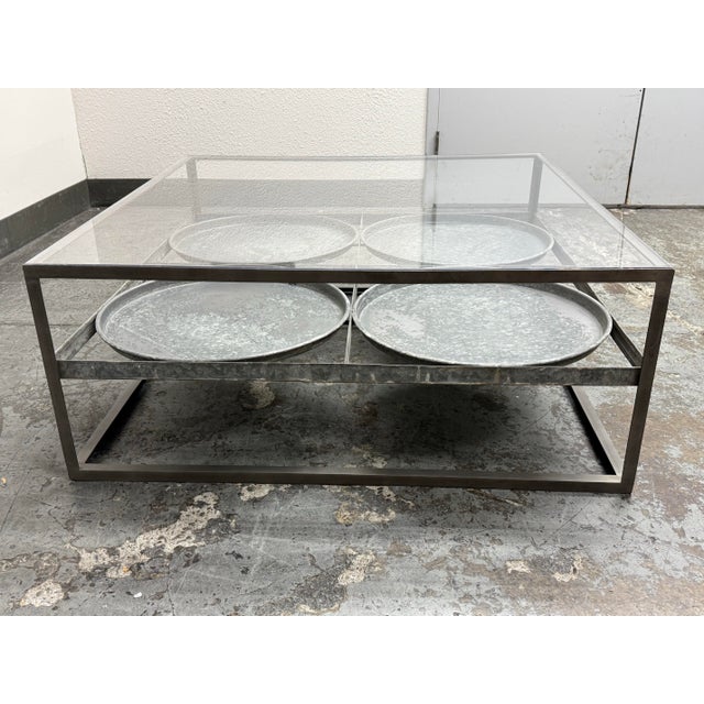 Design Plus Gallery presents the Tilford Glass Top Tray Coffee Table from Blue Ocean Trader. The coffee table has a...