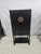 A striking Asian-inspired black lacquer cabinet featuring bold brass medallion hardware, offering a refined blend of...
