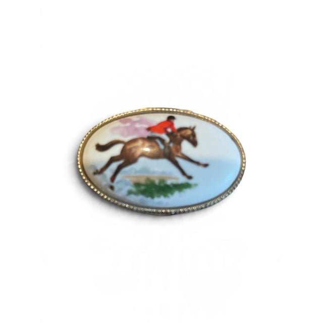 Charmingly classic, this vintage oval pill box features an elegant equestrian theme perfect for collectors or horse...