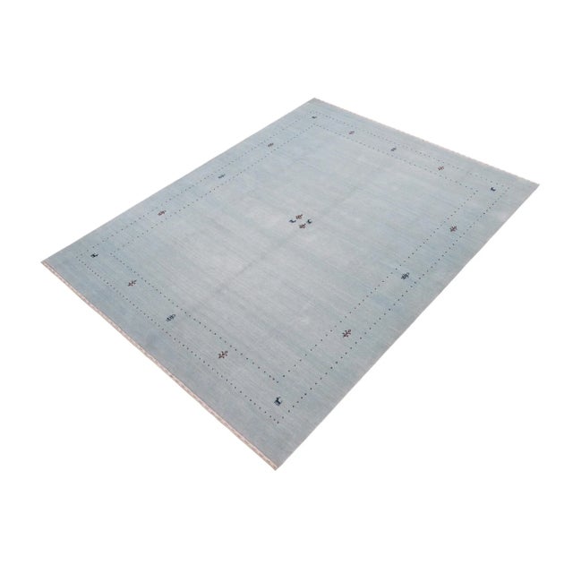 Make a bold statement in your living area with this exquisite Contemporary Gabbeh Wool Rug. It is meticulously hand-...