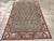 This mid-20th-century Persian Malayer accent rug presents a tightly organized allover design across a muted blue field....