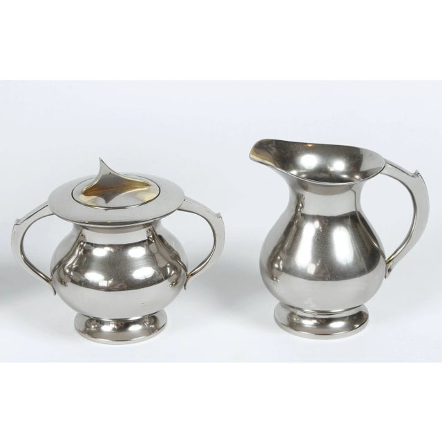 Mid-Century coffee set with coffee pot, tea pot, cream and sugar. Newly polished silver plate over brass. Bottom of coffee...