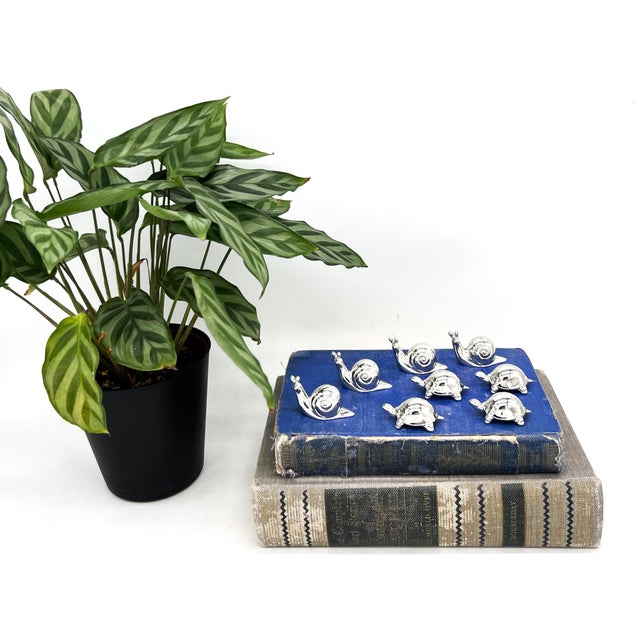 Charming set of eight silver-tone place card holders featuring four snails and four turtles. These delightful tabletop...
