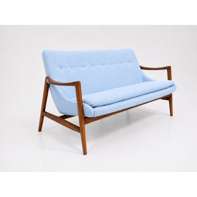Mid-century-style sofa. The sofa was made in the style of Ib Kofod-Larsen. The sofa is stained a light walnut, matte...
