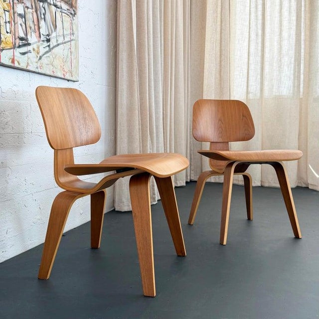 This pair of molded birch plywood DCW chairs (Dining Chair Wood) were designed by Charles and Ray Eames in 1945. The...